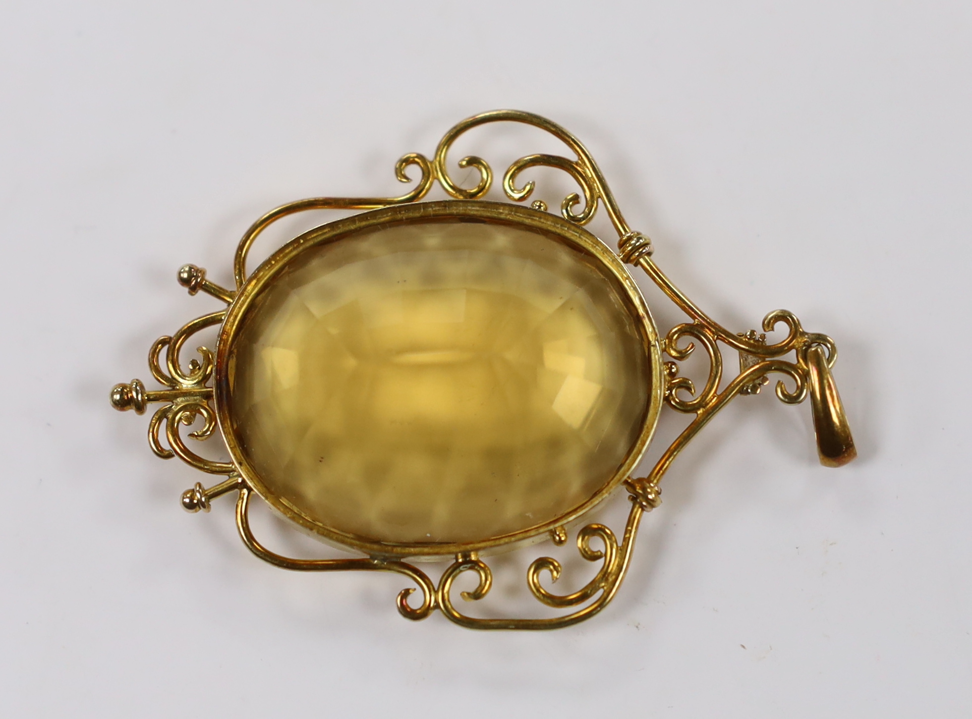 A yellow metal mounted oval cut citrine pendant, overall 56mm, gross weight 15.8 grams.